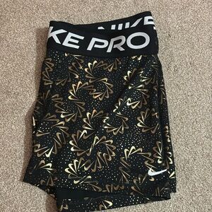 Nike pro women’s large. Black and gold swoosh limited edition. Never worn